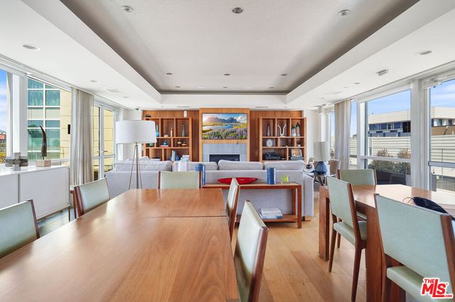 a living room with furniture a wooden floor and a large window
