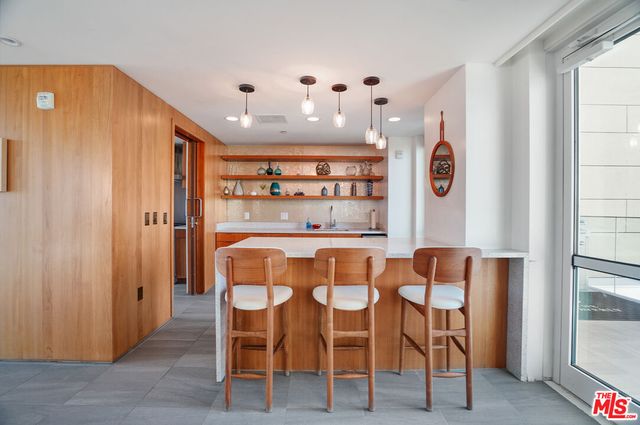 a dining room with furniture and window view