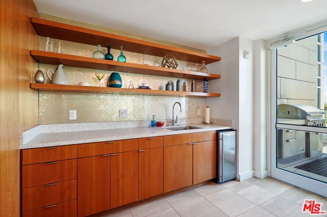 a kitchen with a sink a stove and cabinets