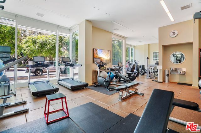 a living room with furniture rug and large windows