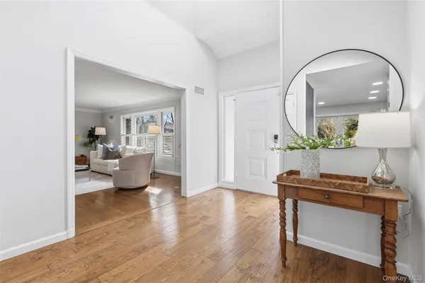 a bathroom with a granite countertop sink a toilet and a mirror