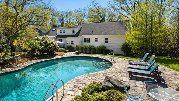a view of a house with a yard patio and sitting area