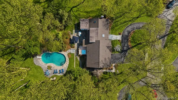 a backyard of a house with table and chairs