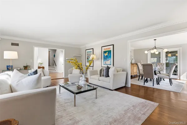 a living room with furniture a flat screen tv and a large window