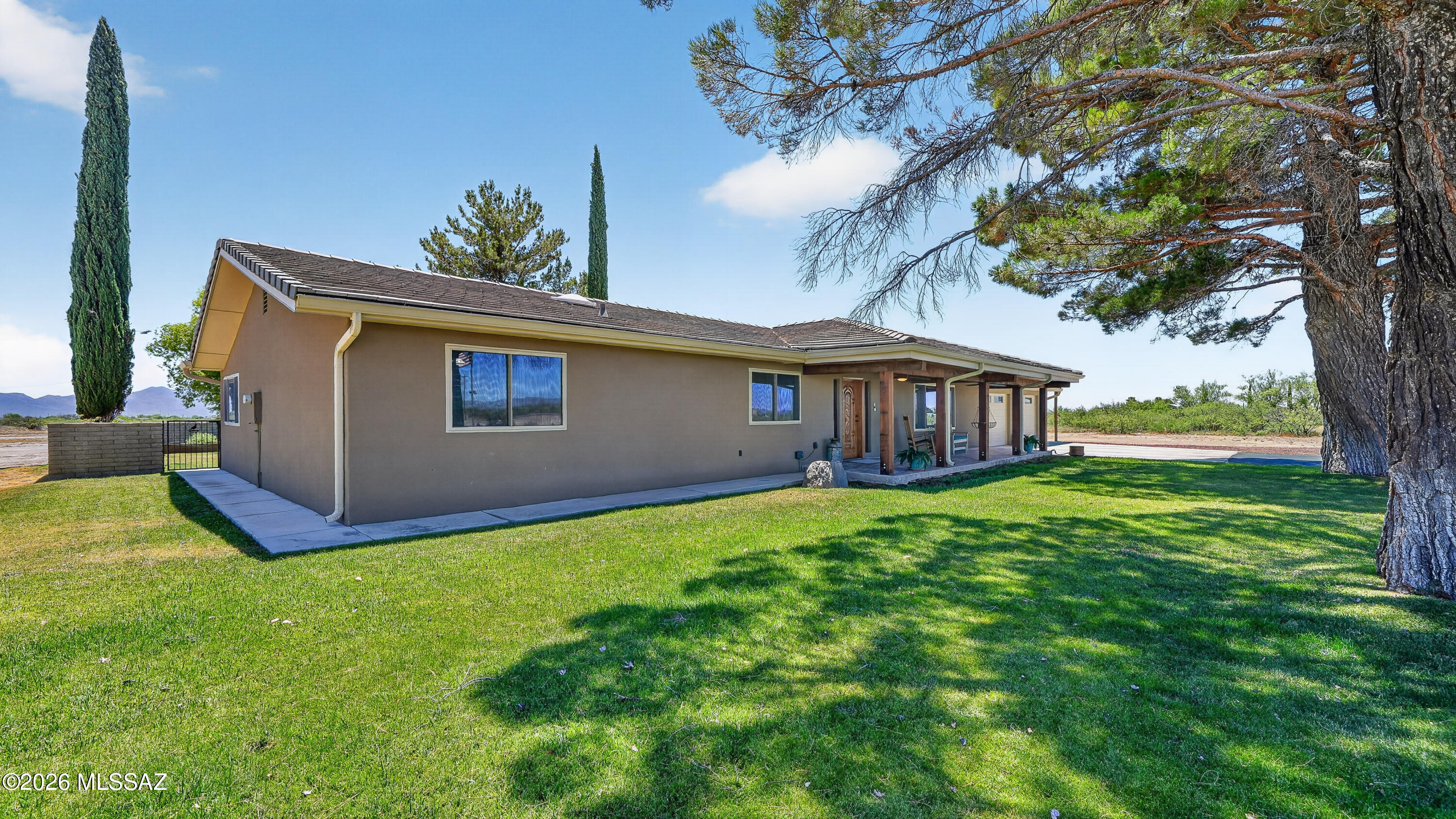 194 Taylor Road Willcox, AZ 85643 - Photo 2 of 54 Front of House, 2 Large Pine Trees, Grass with Inground Automatic Sprinkler System
