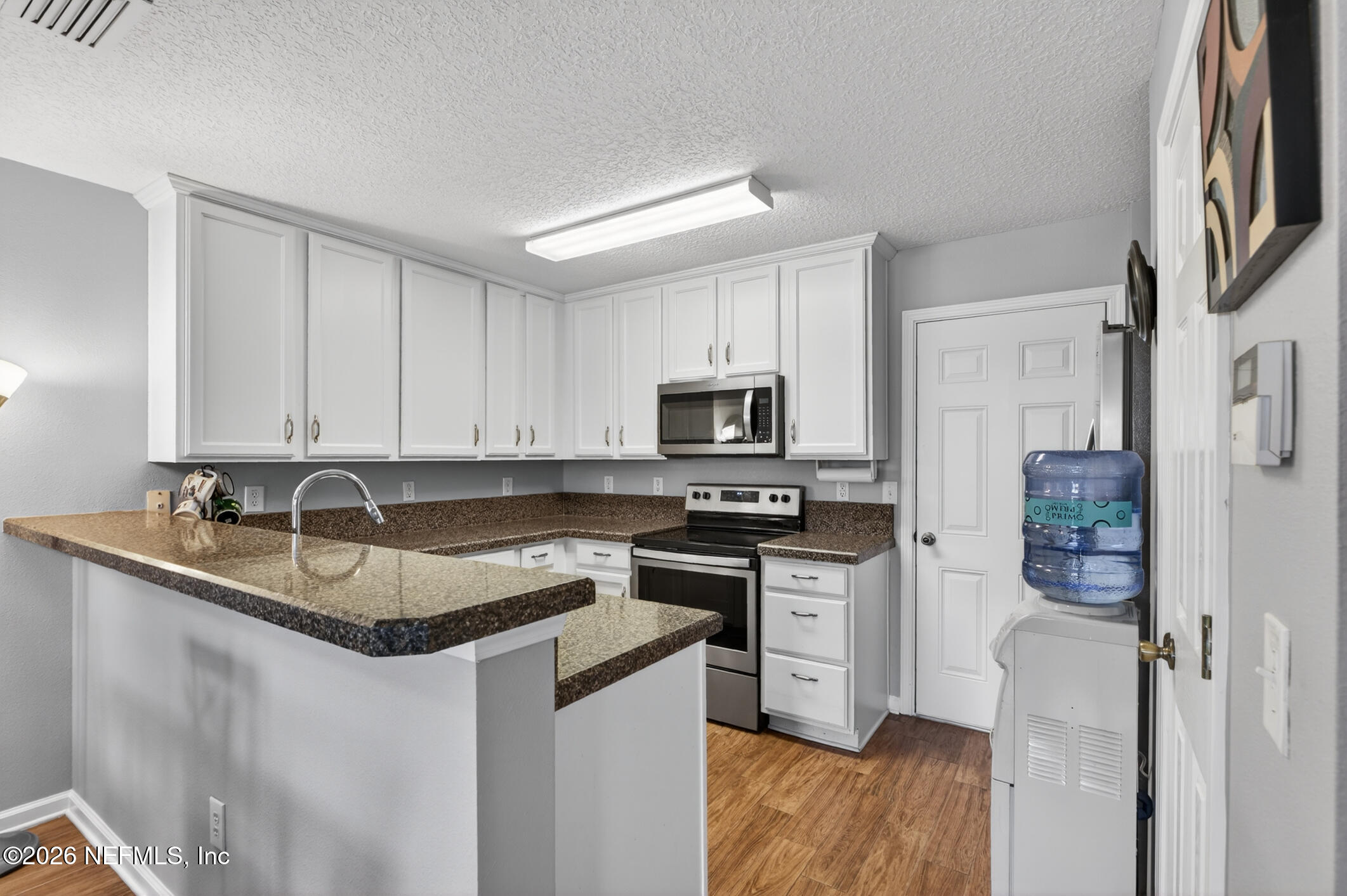 1500 Calming Water Drive, Unit 4603 Fleming Island, FL 32003 - Photo 16 of 98 a kitchen with stainless steel appliances granite countertop a sink stove and refrigerator
