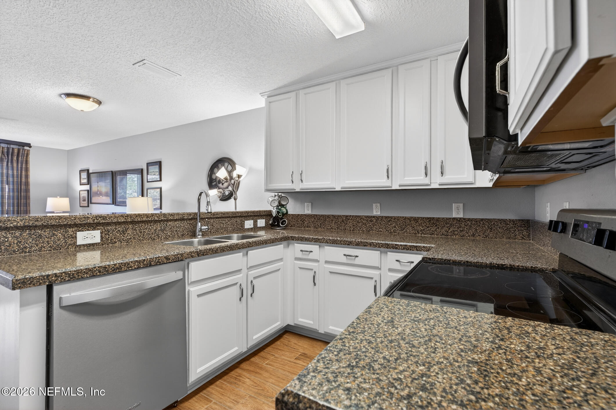 1500 Calming Water Drive, Unit 4603 Fleming Island, FL 32003 - Photo 19 of 98 a kitchen with a sink and cabinets