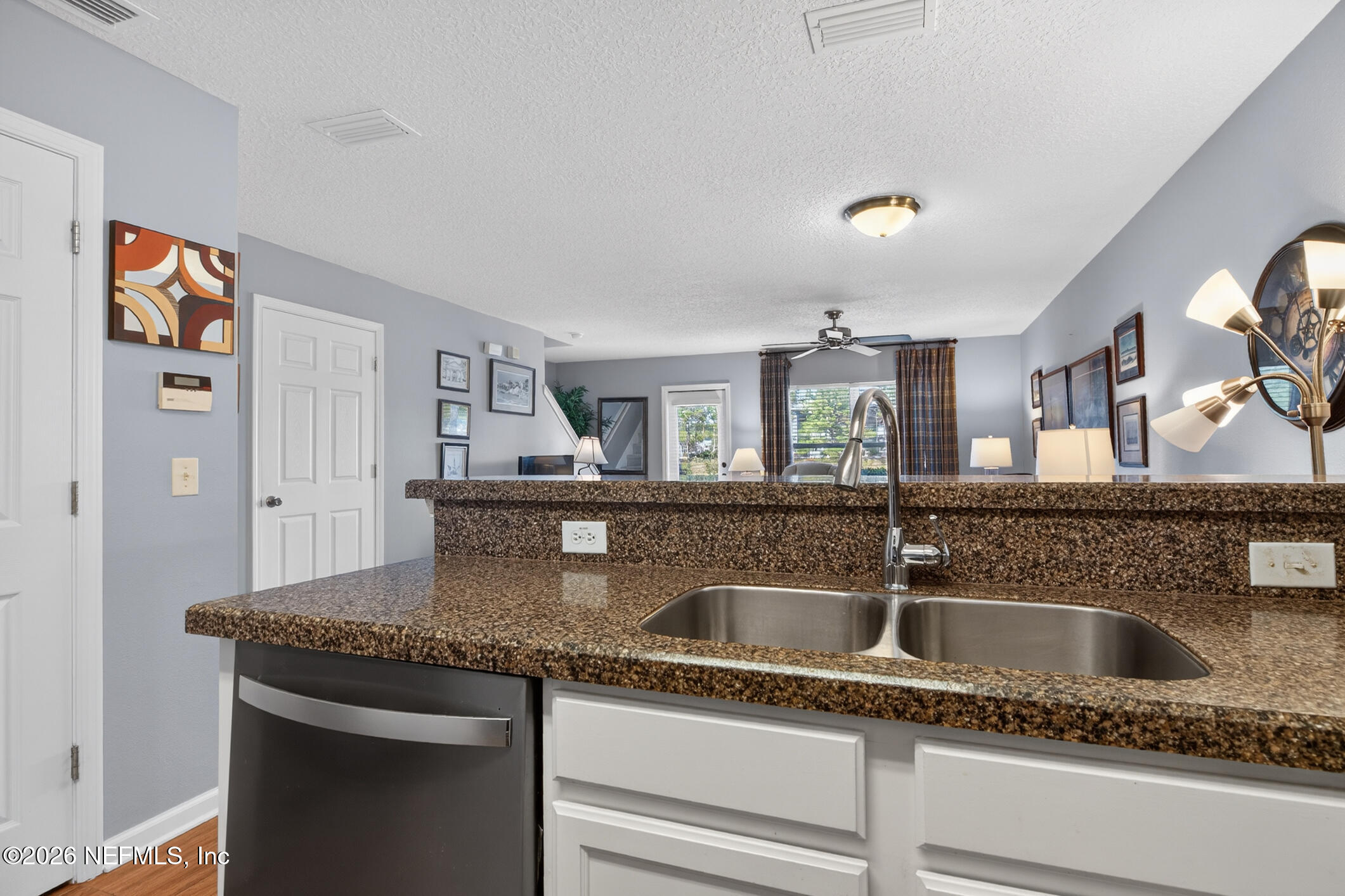 1500 Calming Water Drive, Unit 4603 Fleming Island, FL 32003 - Photo 22 of 98 a kitchen with granite countertop a sink and cabinets