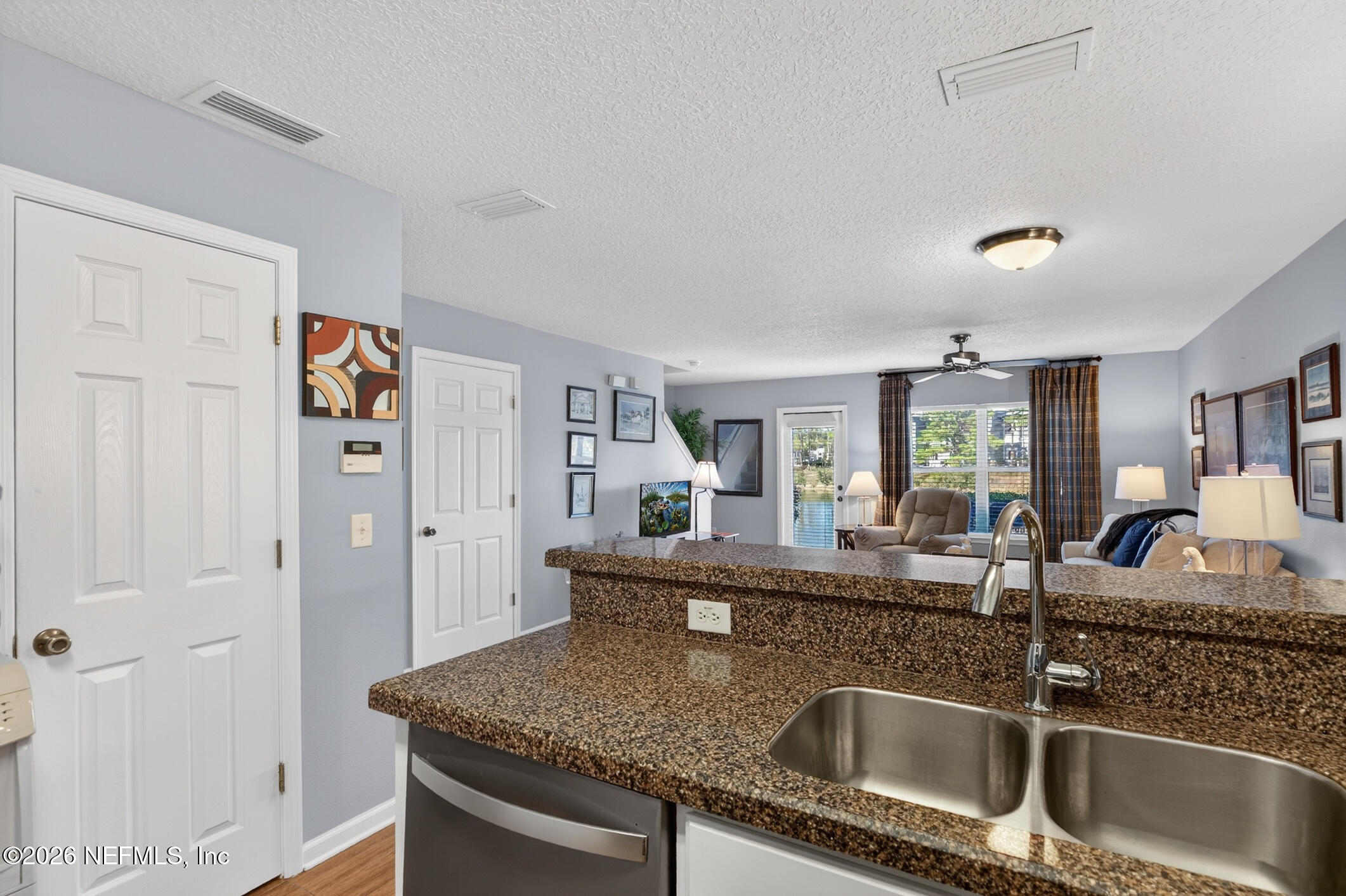 1500 Calming Water Drive, Unit 4603 Fleming Island, FL 32003 - Photo 23 of 98 a kitchen with stainless steel appliances granite countertop a sink and dishwasher with granite countertops