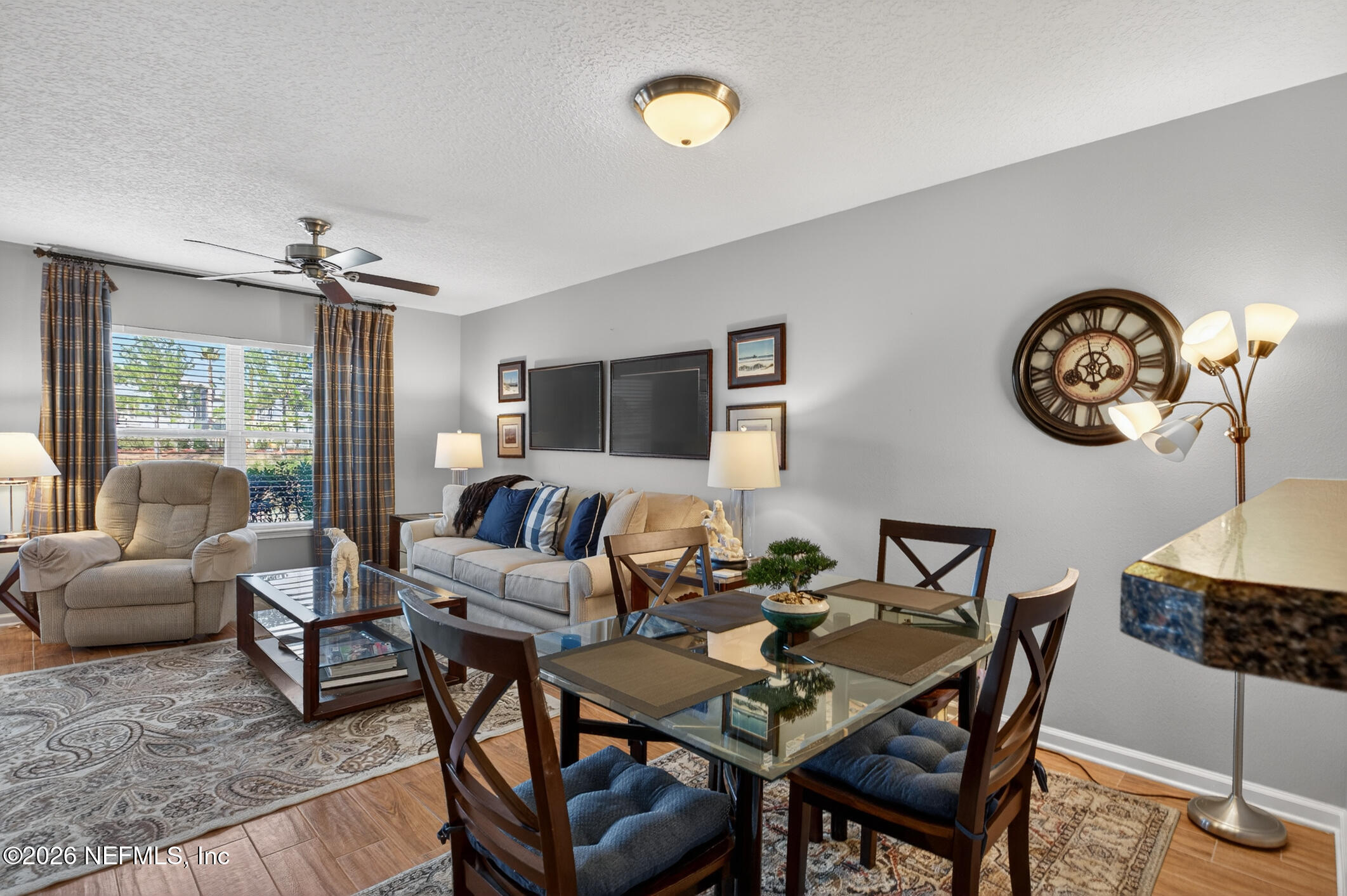 1500 Calming Water Drive, Unit 4603 Fleming Island, FL 32003 - Photo 24 of 98 a living room with furniture a clock and a window