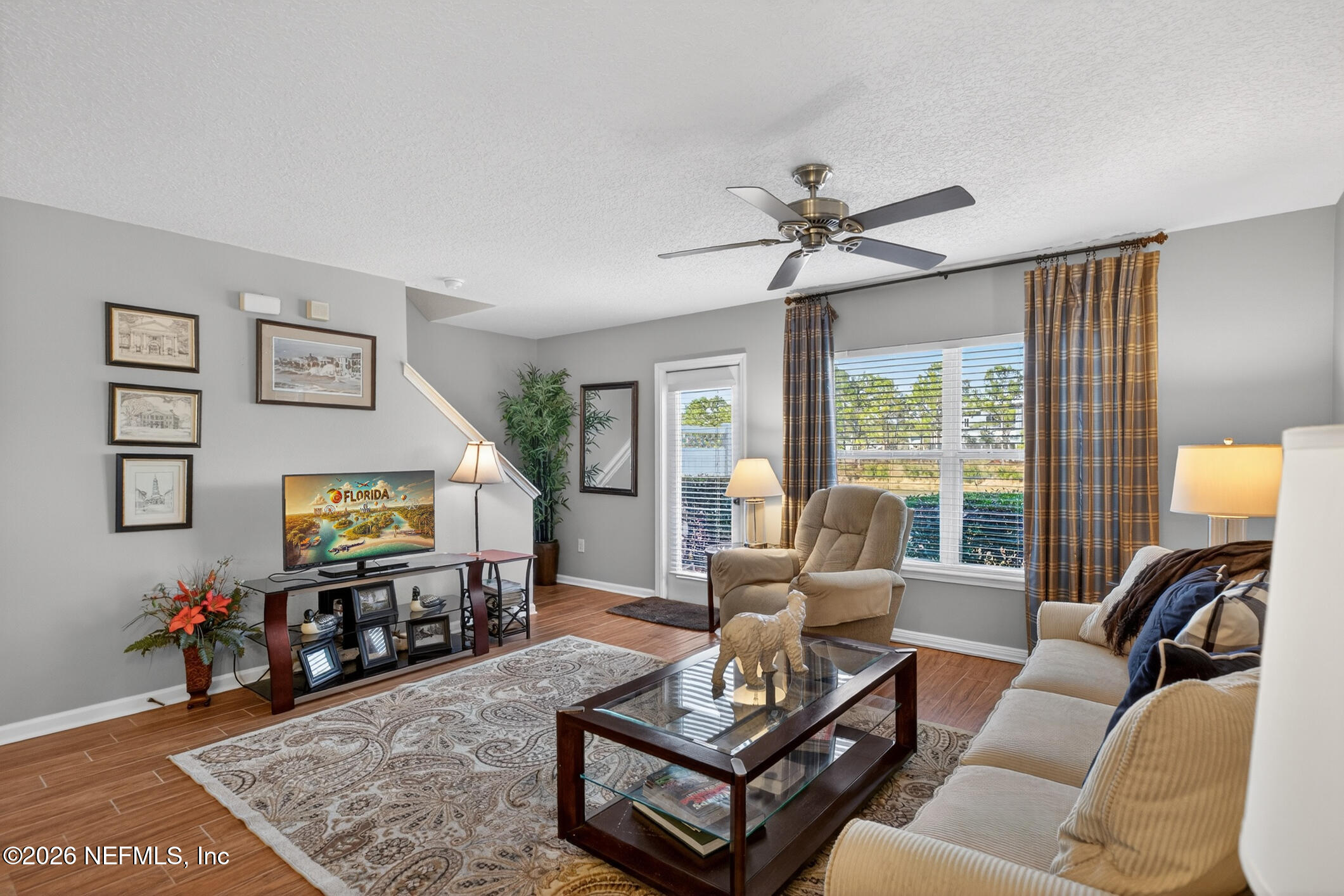 1500 Calming Water Drive, Unit 4603 Fleming Island, FL 32003 - Photo 27 of 98 a living room with furniture and a flat screen tv