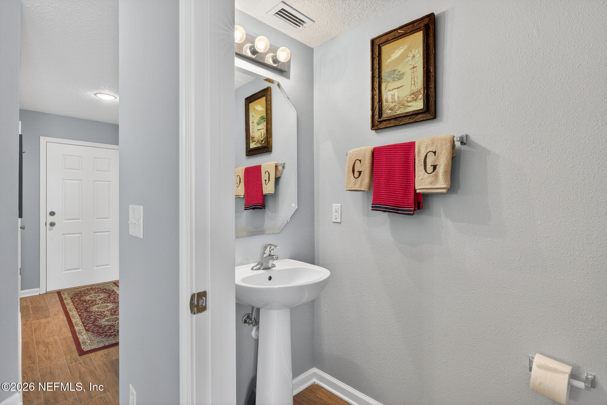 1500 Calming Water Drive, Unit 4603 Fleming Island, FL 32003 - Photo 30 of 98 a bathroom with a sink and a mirror