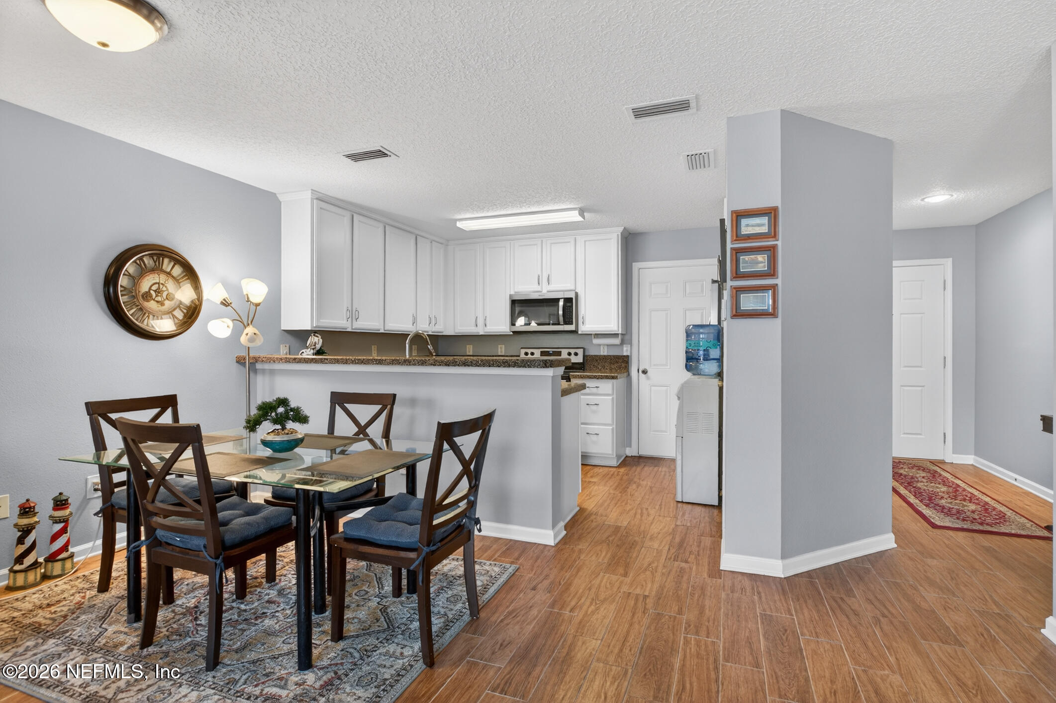1500 Calming Water Drive, Unit 4603 Fleming Island, FL 32003 - Photo 31 of 98 a kitchen with a table chairs a refrigerator a stove a dining table and chairs