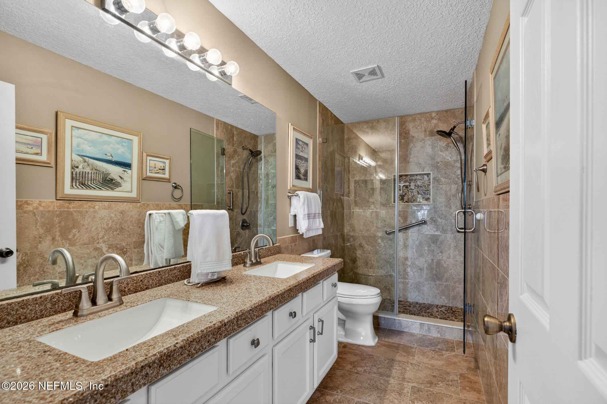 1500 Calming Water Drive, Unit 4603 Fleming Island, FL 32003 - Photo 38 of 98 a bathroom with a granite countertop double vanity sink a mirror and a shower