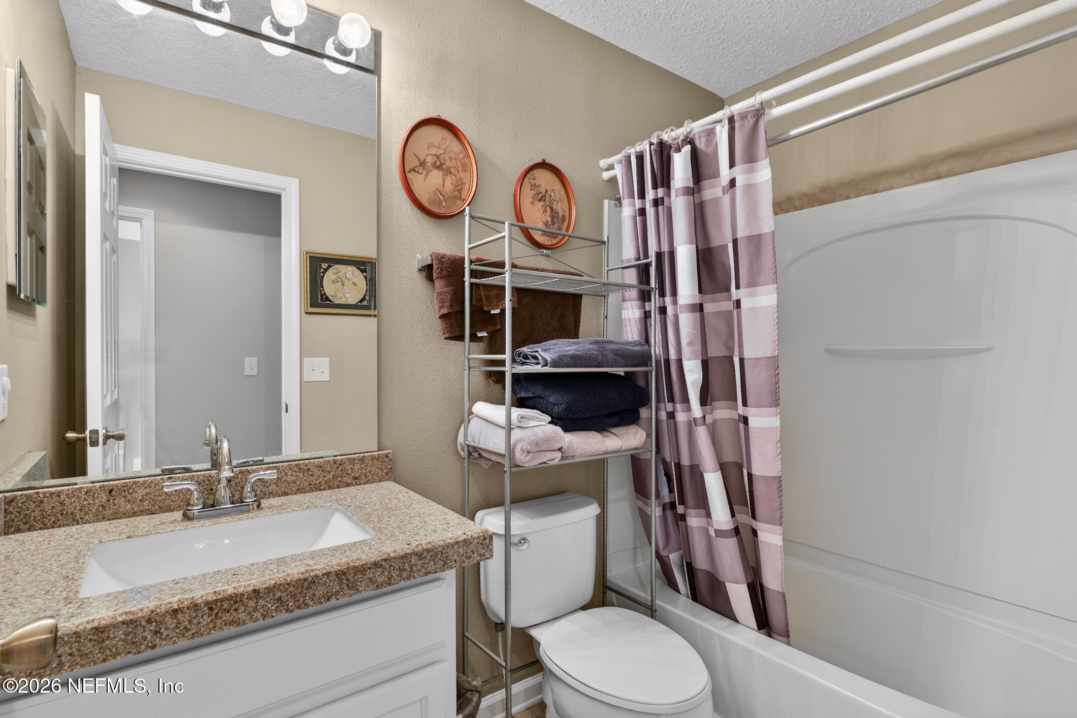 1500 Calming Water Drive, Unit 4603 Fleming Island, FL 32003 - Photo 44 of 98 a bathroom with a granite countertop toilet sink and mirror