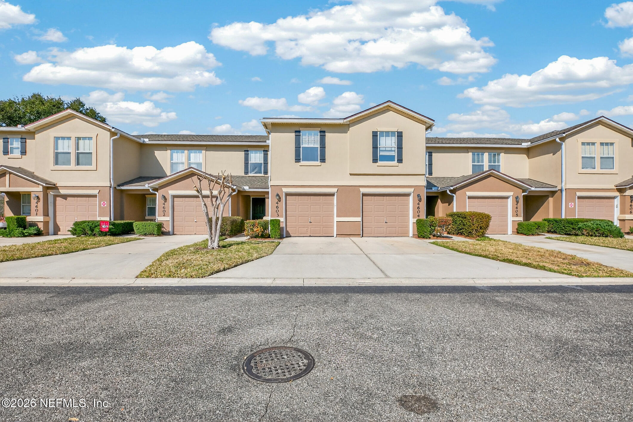 1500 Calming Water Drive, Unit 4603 Fleming Island, FL 32003 - Photo 5 of 98 a front view of a house with a yard and garage