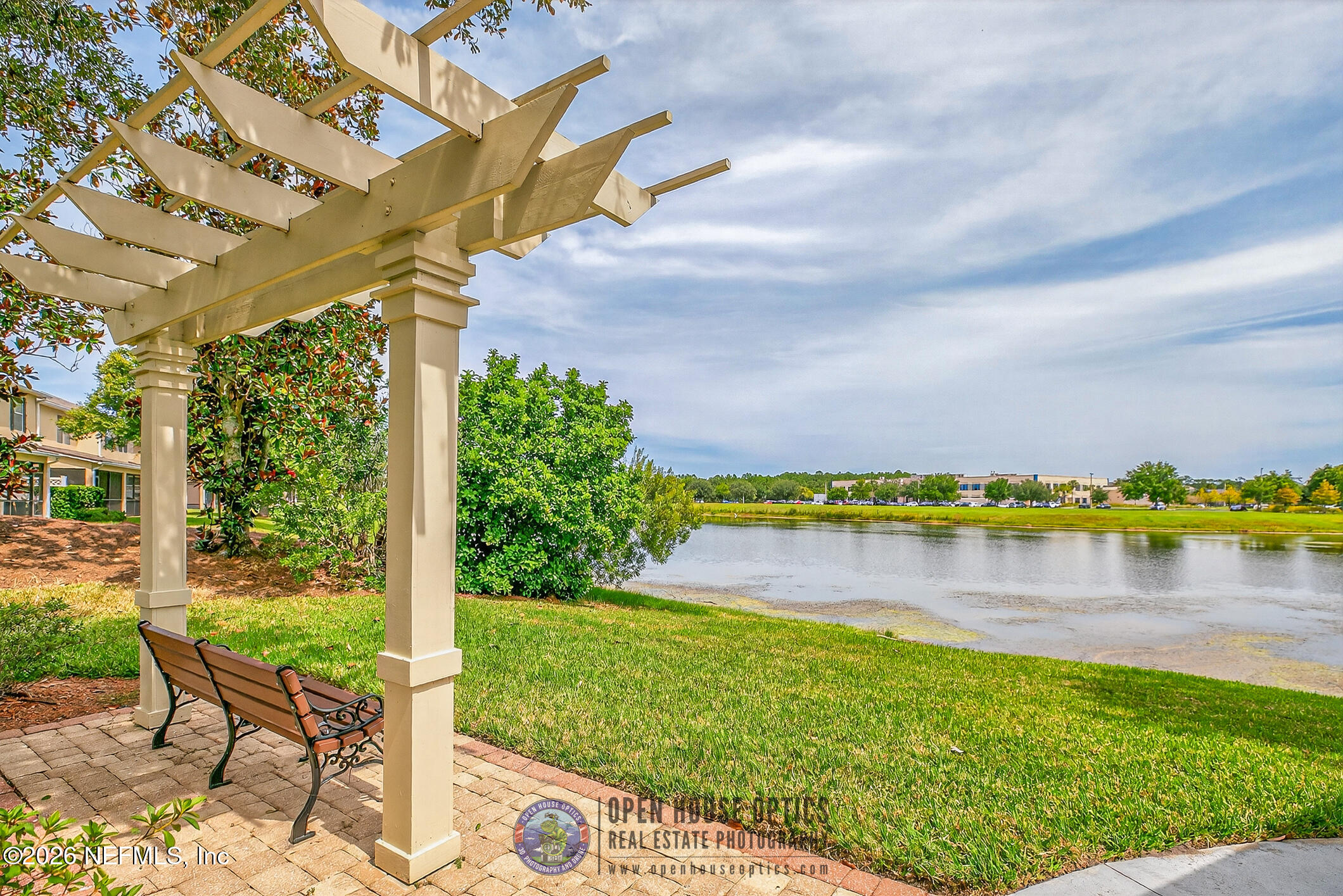 1500 Calming Water Drive, Unit 4603 Fleming Island, FL 32003 - Photo 74 of 98 a view of a lake with a big yard and large trees