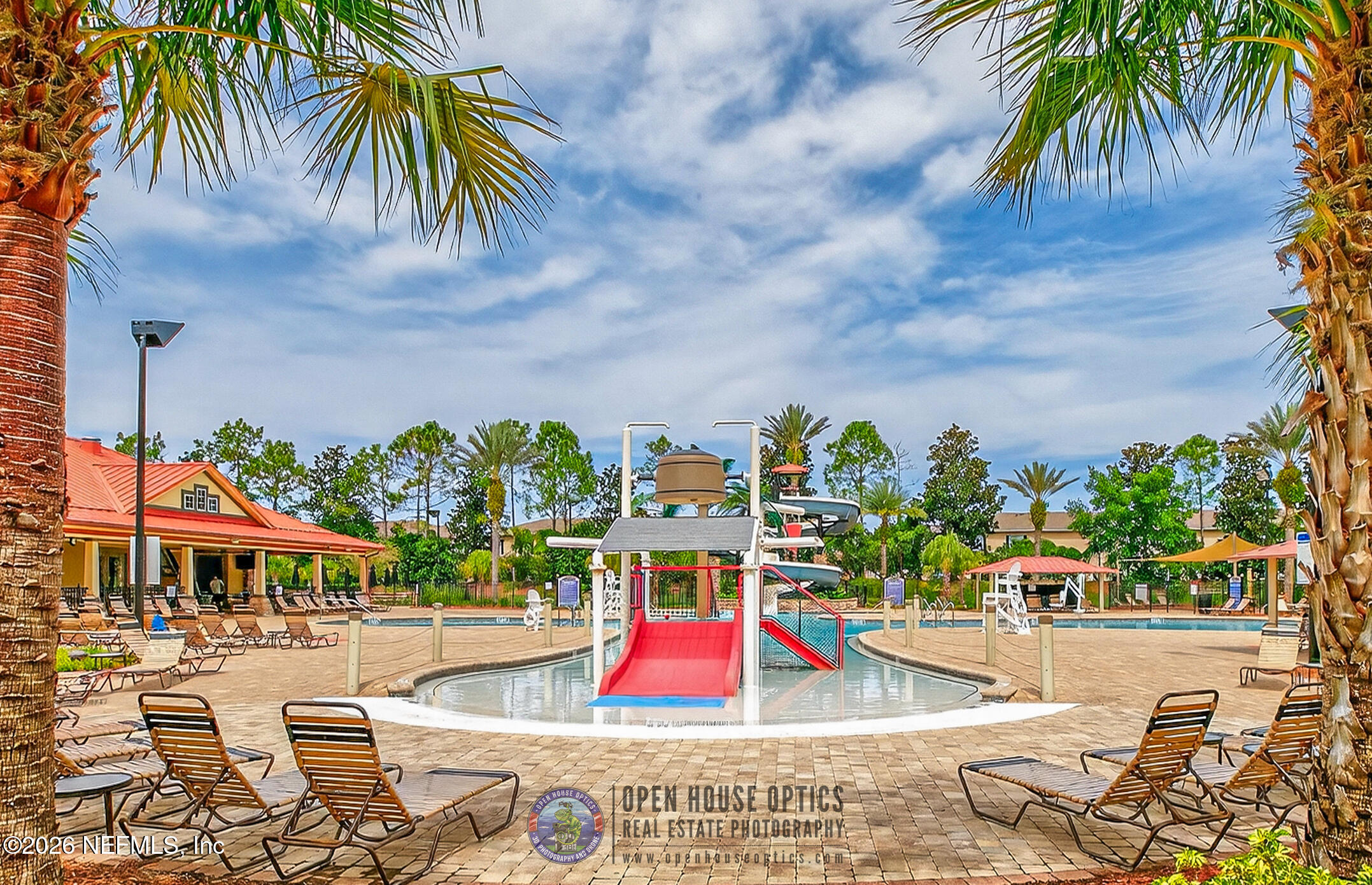 1500 Calming Water Drive, Unit 4603 Fleming Island, FL 32003 - Photo 79 of 98 a view of a swimming pool with a lawn chairs under an umbrella