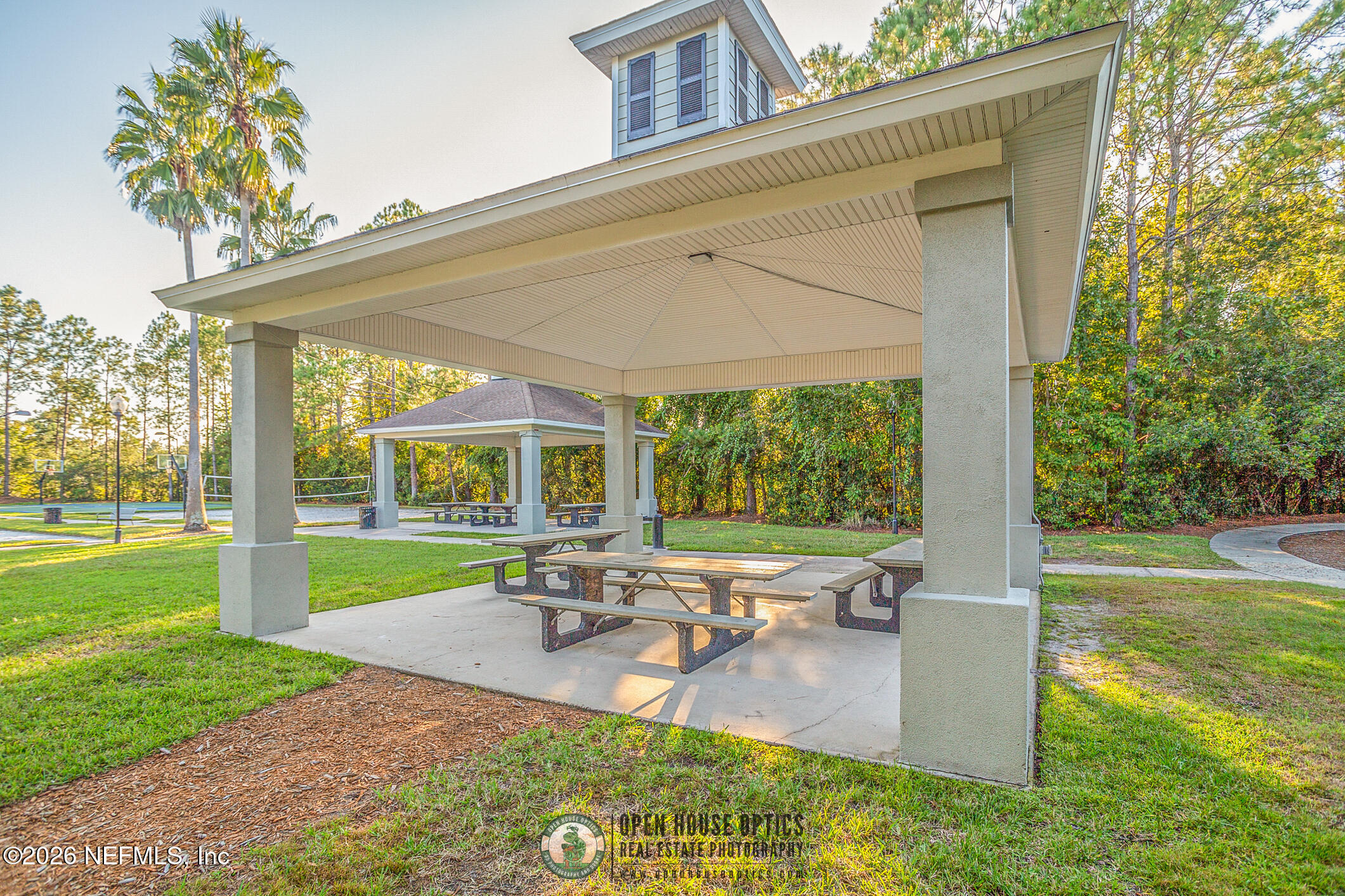 1500 Calming Water Drive, Unit 4603 Fleming Island, FL 32003 - Photo 94 of 98 a view of a patio with table and chairs potted plants and a big yard