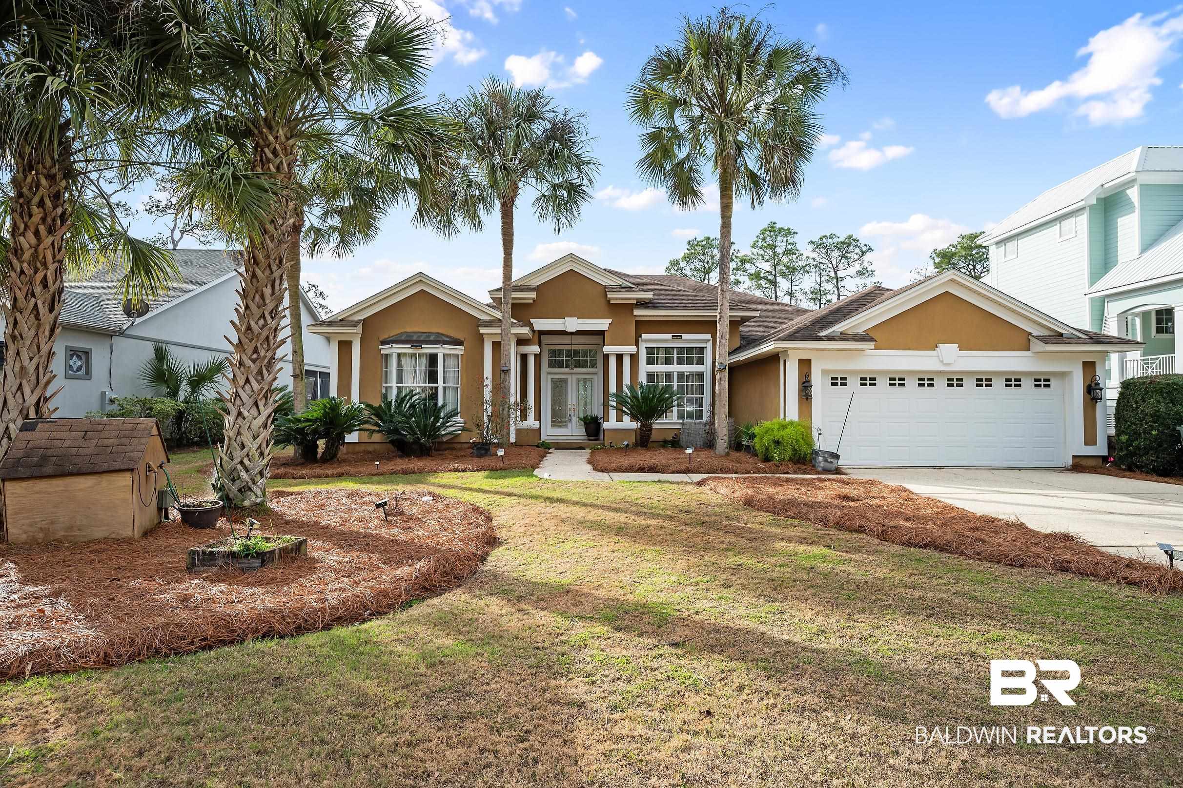 8591 Bay Harbor Road Elberta, AL 36530 - Photo 53 of 56 View of front facade with a front yard, stucco siding, driveway, and an attached garage