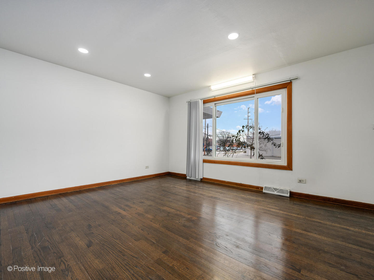 68 North Albert Street Mount Prospect, IL 60056 - Photo 3 of 15 a view of an empty room with wooden floor and a window