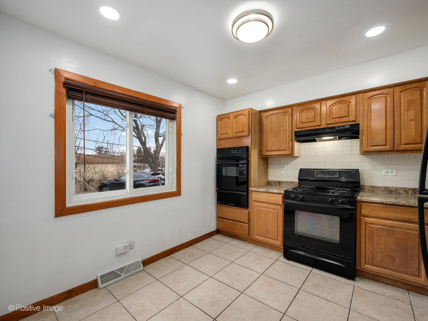 68 North Albert Street Mount Prospect, IL 60056 - Photo 6 of 15 a kitchen with stainless steel appliances granite countertop a stove top oven microwave and refrigerator