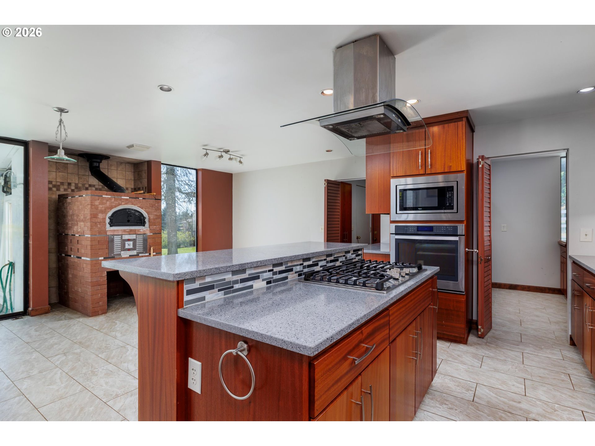 3251 Southwest Redmond Hill Road McMinnville, OR 97128 - Photo 13 of 46 a kitchen that has a kitchen island wooden cabinets and stainless steel appliances