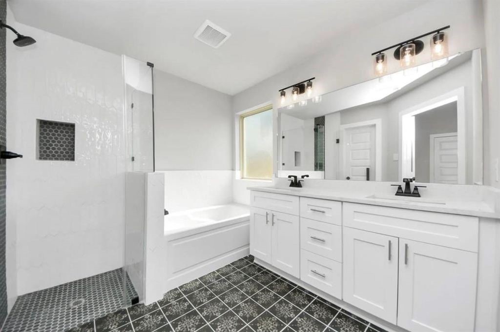 3527 Windmill Palm Drive Manvel, TX 77578 - Photo 11 of 13 a spacious bathroom with a double vanity sink a mirror and a bathtub