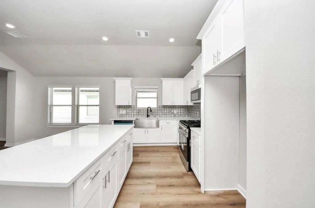 3527 Windmill Palm Drive Manvel, TX 77578 - Photo 5 of 13 a large white kitchen with a large window