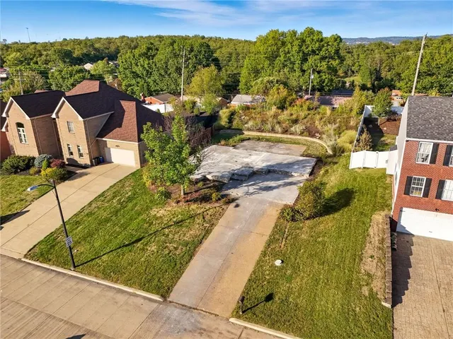 an aerial view of a houses with a yard