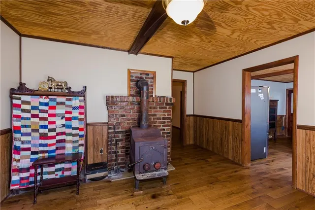 a kitchen with stainless steel appliances granite countertop a stove a sink dishwasher a dining table and chairs with wooden floor