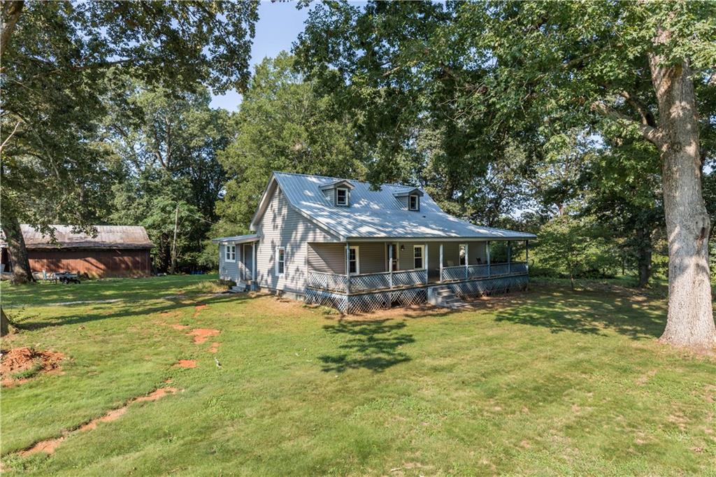 933 Alto-Mud Creek Road Alto, GA 30510 - Photo 2 of 41 a view of a big house with a big yard and large trees