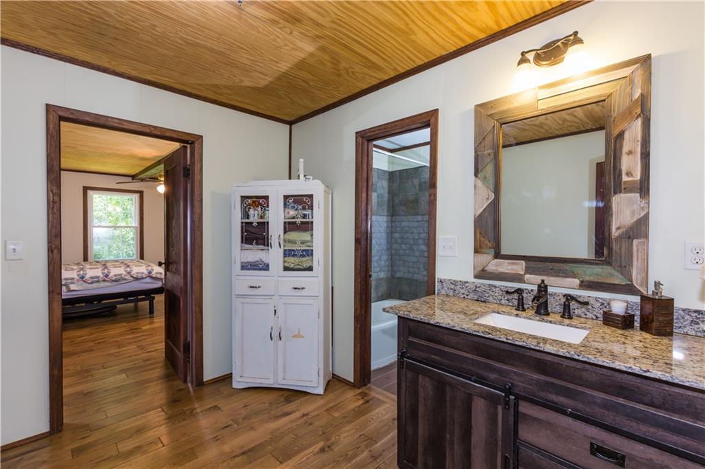 933 Alto-Mud Creek Road Alto, GA 30510 - Photo 24 of 41 a en suite bathroom with a granite countertop sink and a mirror