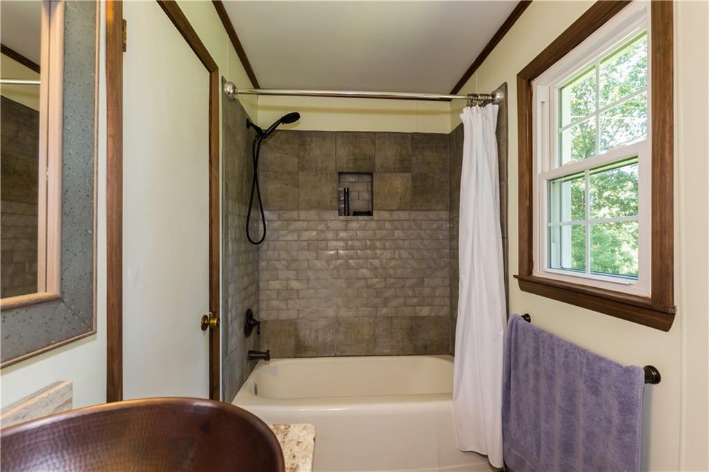933 Alto-Mud Creek Road Alto, GA 30510 - Photo 27 of 41 a bathroom with a bathtub and a shower