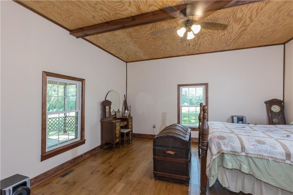 933 Alto-Mud Creek Road Alto, GA 30510 - Photo 30 of 41 a bedroom with a bed and a chandelier