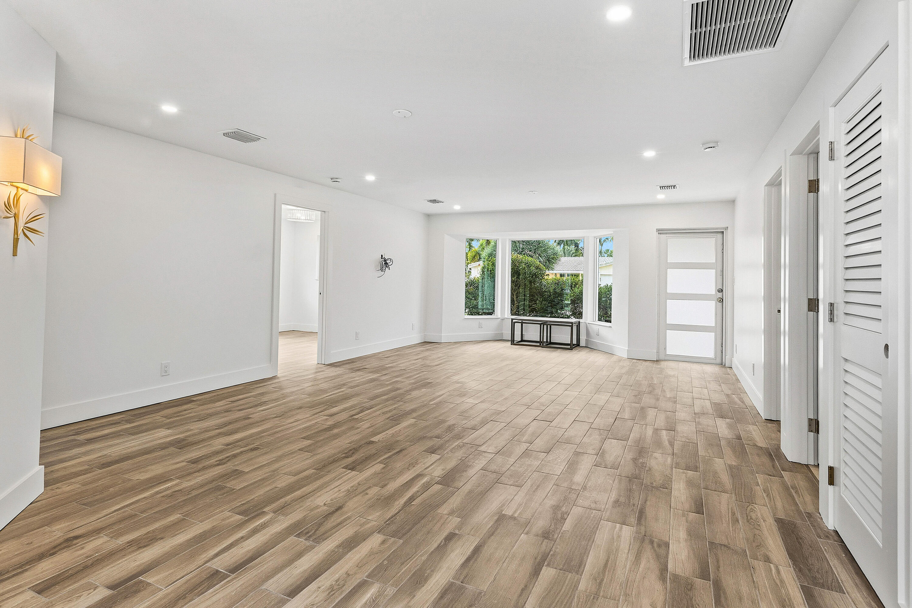 1254 Southwest 4th Court Boca Raton, FL 33432 - Photo 2 of 35 a view of an empty room with wooden floor and a window