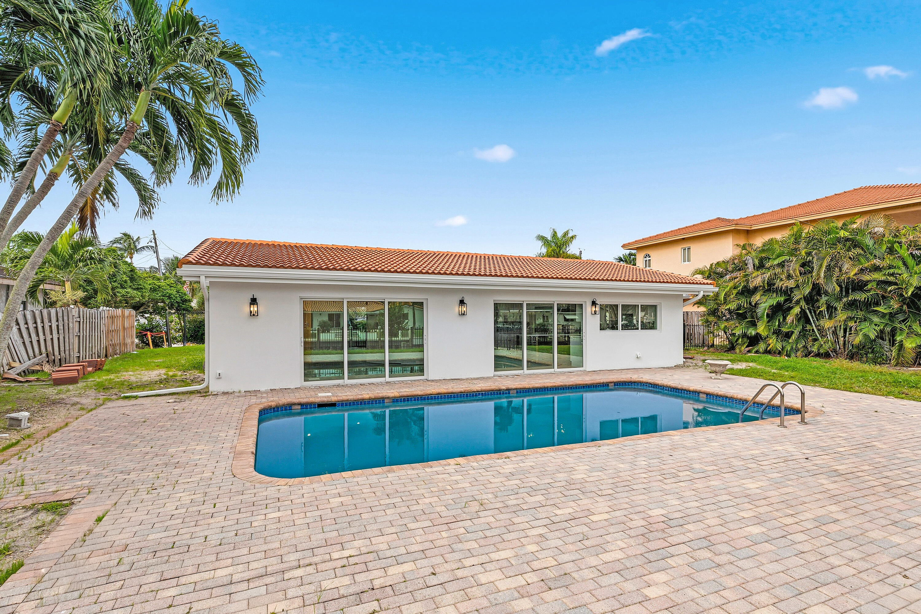 1254 Southwest 4th Court Boca Raton, FL 33432 - Photo 22 of 35 a view of a house with a swimming pool and a yard