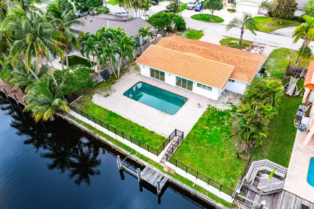 an aerial view of a house with a garden and plants