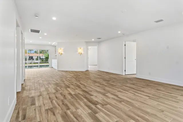 a view of an empty room and wooden floor