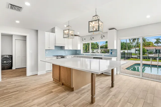 a living room with kitchen island furniture and a kitchen view