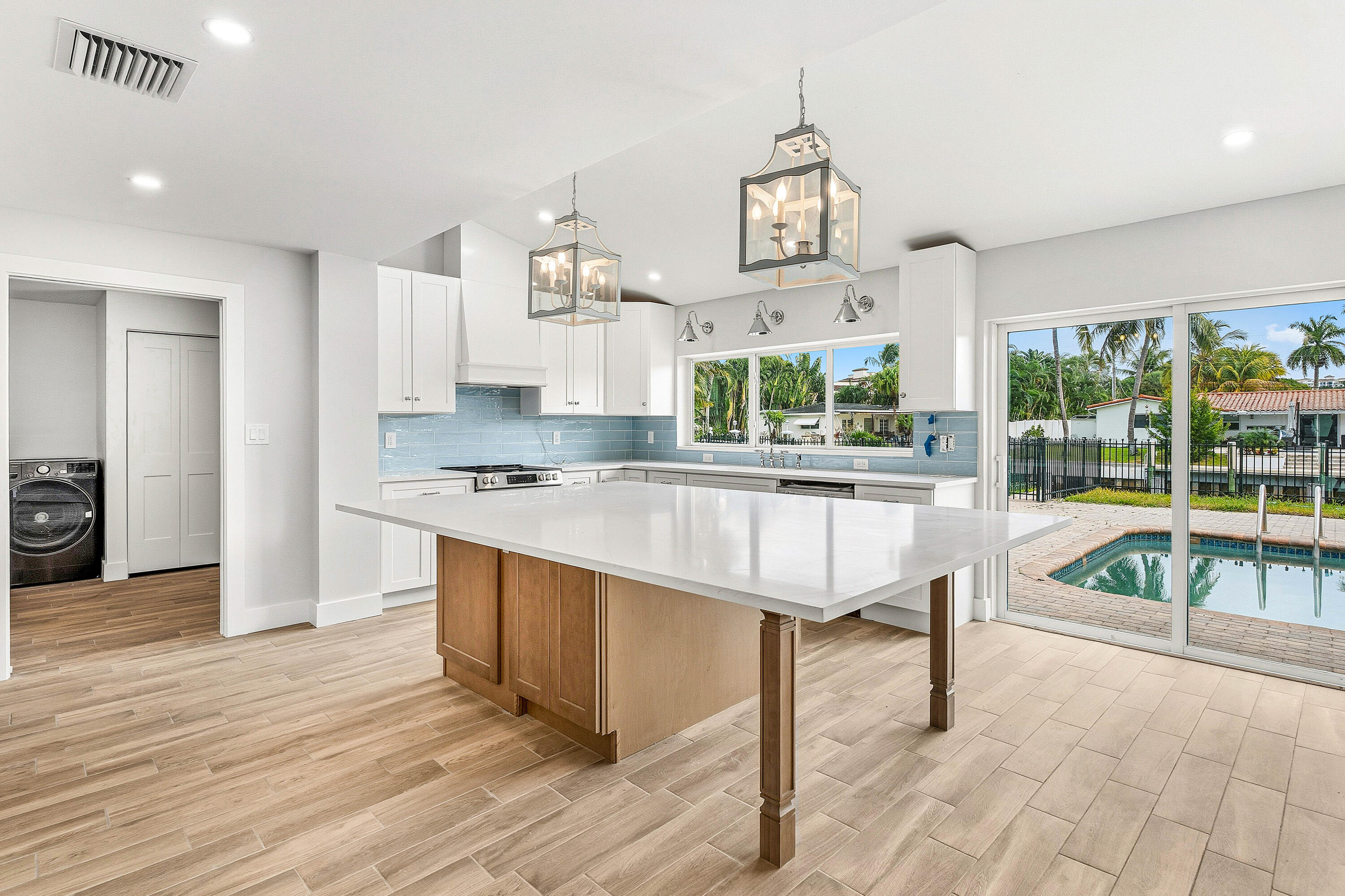 1254 Southwest 4th Court Boca Raton, FL 33432 - Photo 6 of 35 a living room with kitchen island furniture and a kitchen view