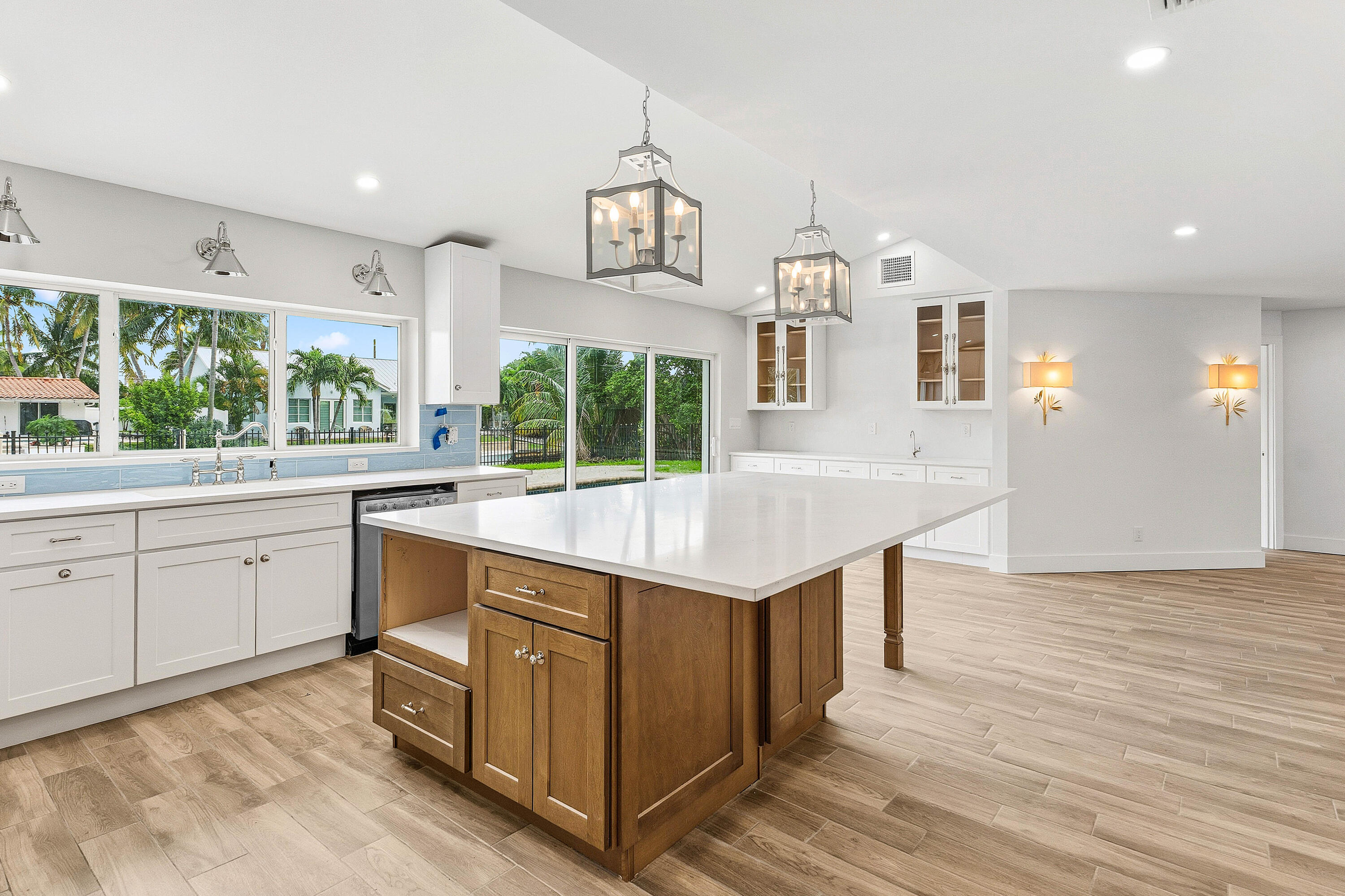 1254 Southwest 4th Court Boca Raton, FL 33432 - Photo 9 of 35 a kitchen with stainless steel appliances granite countertop a stove and a wooden floors