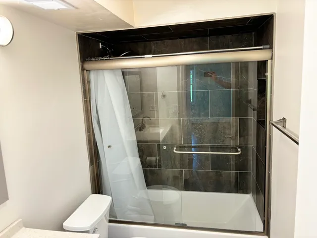 a bathroom with a shower and toilet
