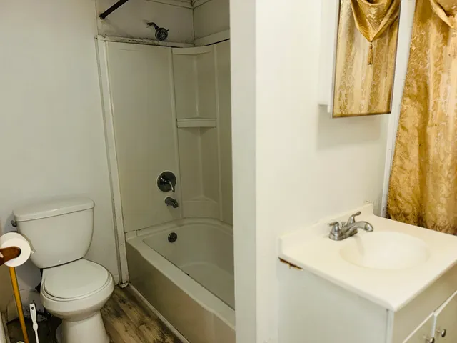 a bathroom with a sink toilet and shower