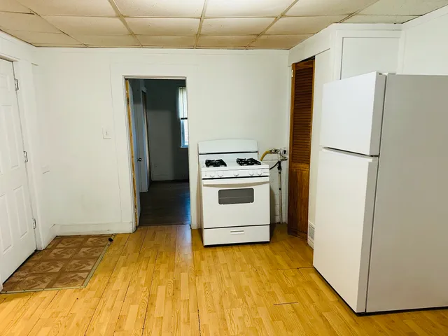 a kitchen with a refrigerator and a stove