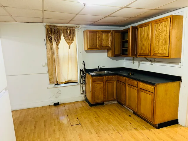a kitchen with a sink a counter top space and stainless steel appliances