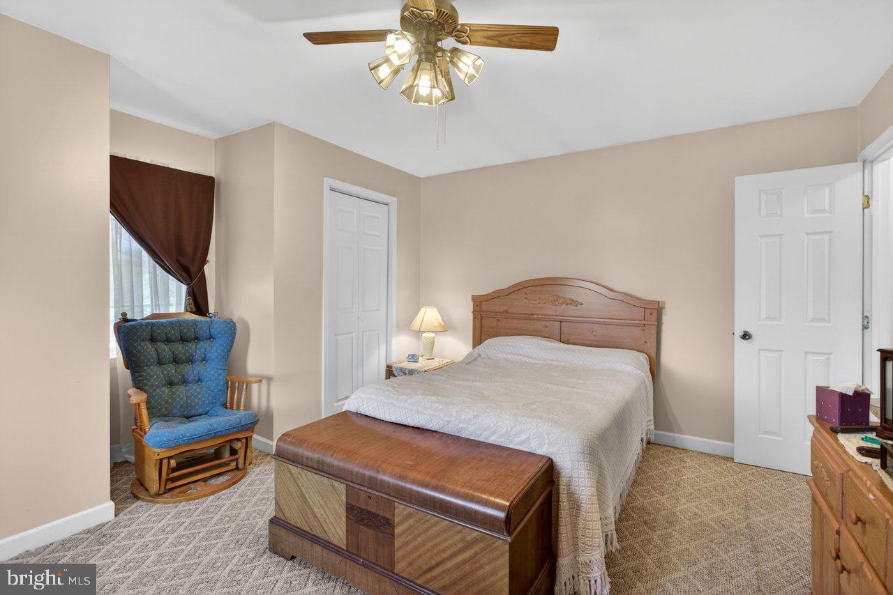 1751 Orchard Road Mount Jackson, VA 22842 - Photo 18 of 30 a bedroom with a bed and a chandelier