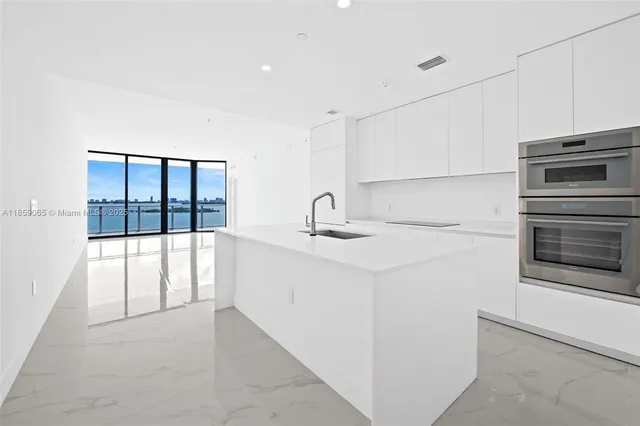 a kitchen with white cabinets and white appliances