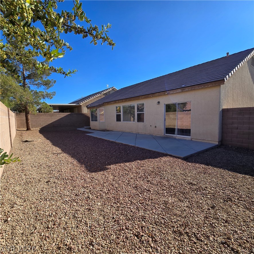 9234 Kingston Road Henderson, NV 89074 - Photo 2 of 38 A spacious backyard with a generous concrete patio offers abundant space for outdoor activities.