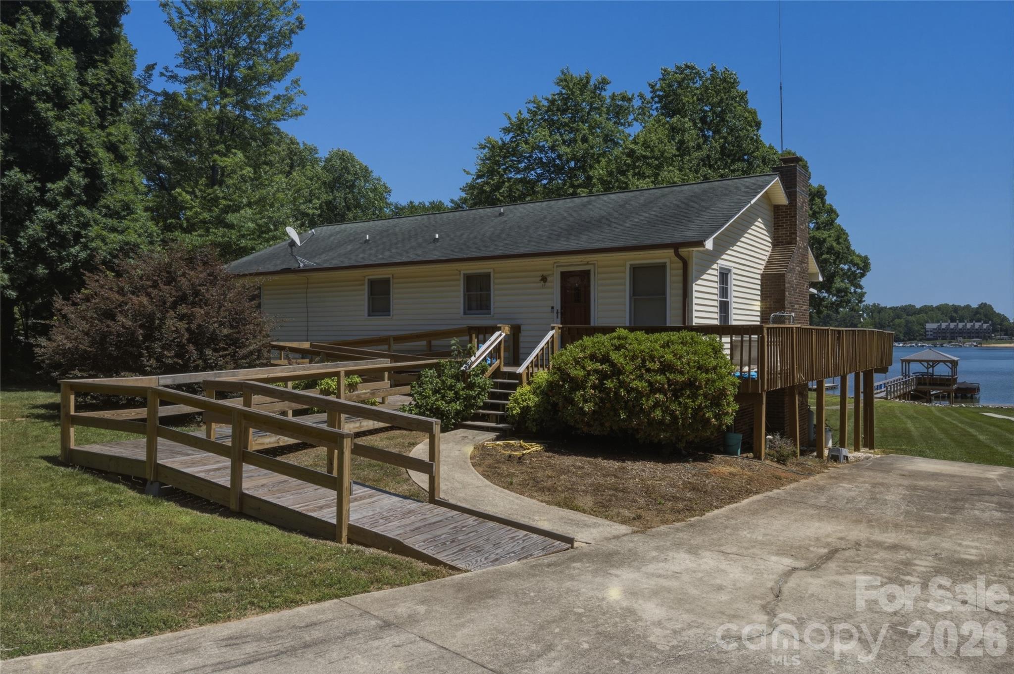 8226 Normandy Road Denver, NC 28037 - Photo 2 of 29 a view of a house with backyard and sitting area